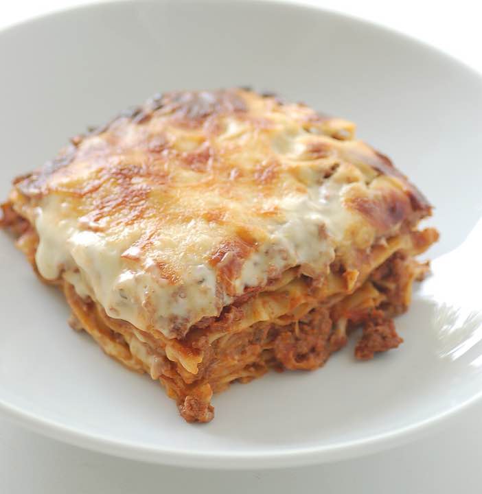 A slice of beef lasagne on a plate